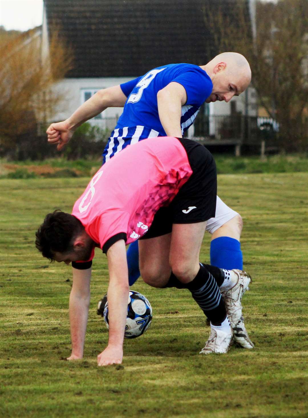 Lybster's Gary Weir tangles with Colin Henstridge of Wick Thistle. Picture: Alan Hendry
