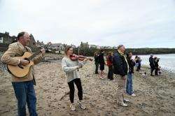 Renowned local fiddler Karen Steven welcomes home the swimmers at Thurso beach with a rendition of her fundraising tune ‘Matty’s Appeal’.