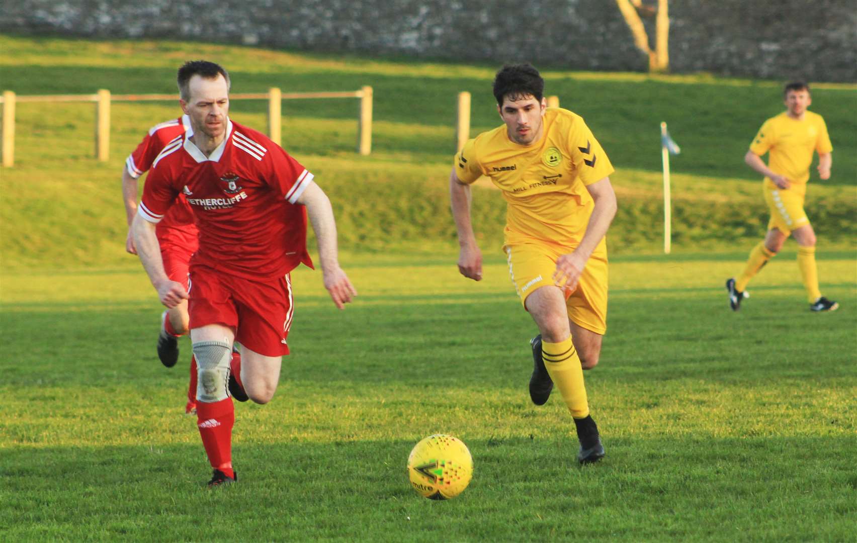 Sean Stewart of Wick Groats and Hasheem Bremner of Staxigoe United chase the ball during Tuesday night's Division One game at the Upper Bignold Park.