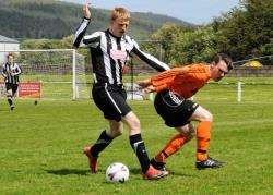Wick Academy's Colin Sinclair gets the better of Sean McIntosh, of Rothes, at the game at Mackessack Park.