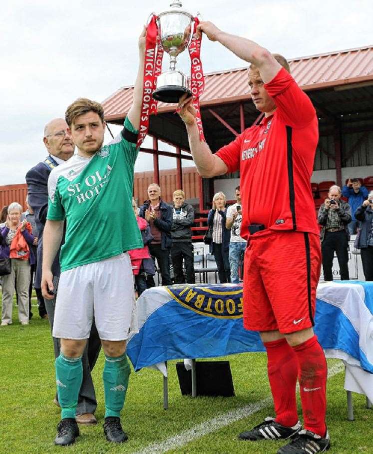 Alan Sinclair with Thorfinn Stout, of Kirkwall Thorfinn, raising the trophy together in tribute to Steven Miller in 2016. Picture: James Gunn