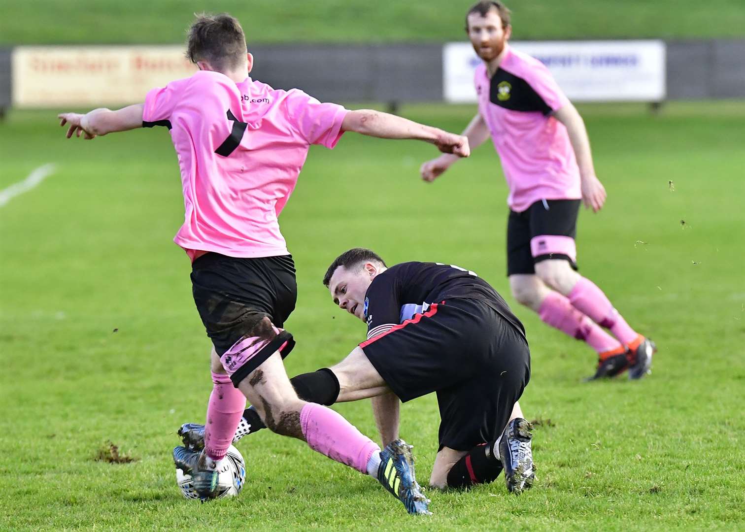Wick's Gordon MacNab stretches in to steal the ball from Clach's Alasdair Gillies. Picture: Mel Roger