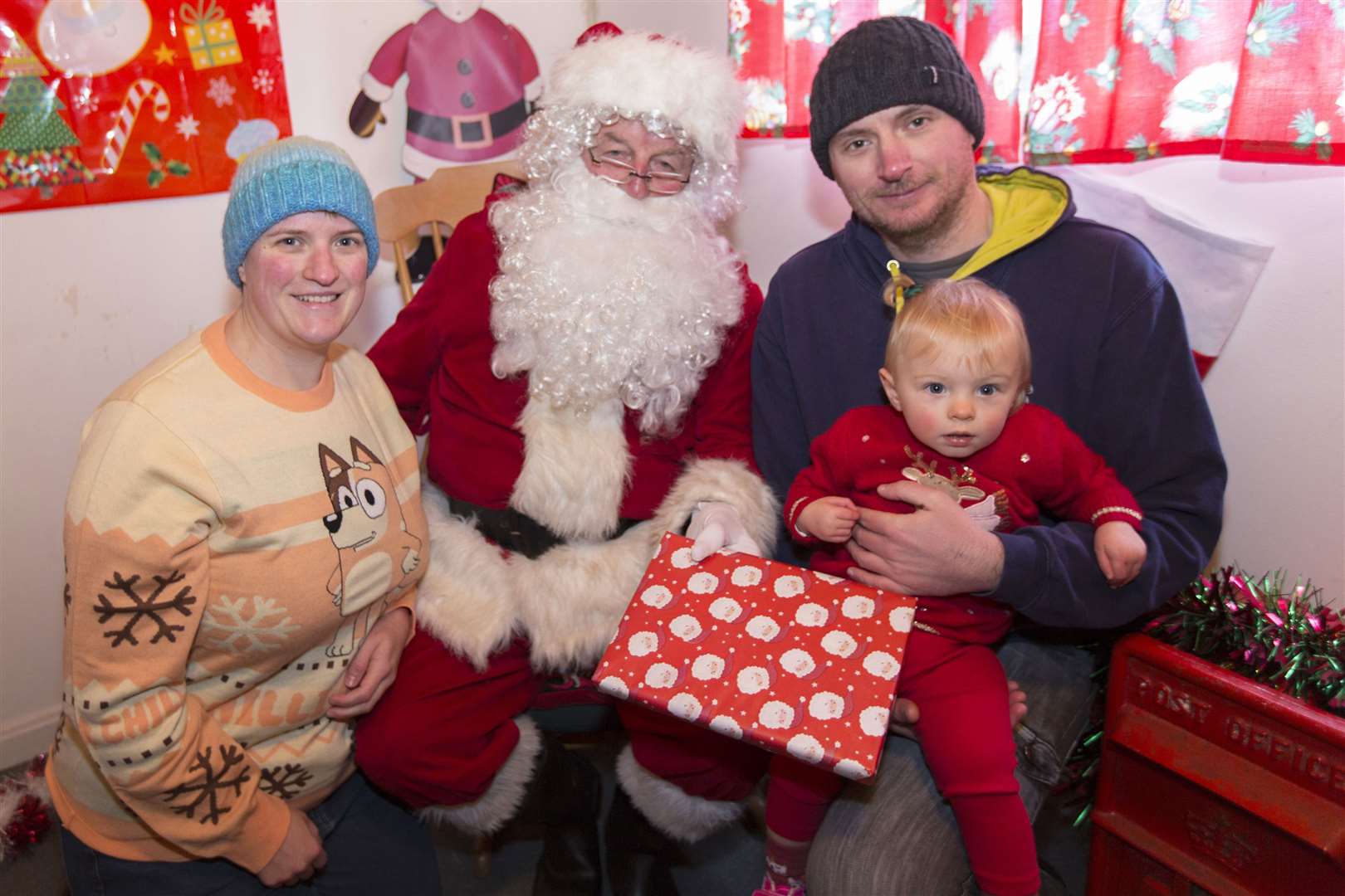 Seventeen-month-old Skye Gannon with Santa, along with her mum Kyrie Mackay and dad Barry Gannon. Picture: Robert MacDonald / Northern Studios
