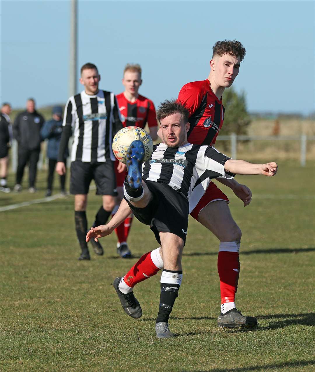 Declan Cooper of Alness United kicks clear from Halkirk United's Stuart Campbell during last weekend's North Caledonian League match at Morrison Park. Picture: James Gunn