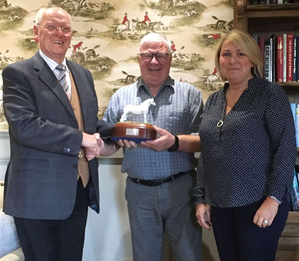 Wick man David Munro receiving the Bambi trophy – the local Riding for the Disabled Association volunteers' award – from Jimmy Johnston, while looking on is Caithness RDA chairperson Judith Miller. The Bambi trophy was presented to the group by Elizabeth Gunn, one of the founding members.