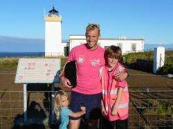 Graham Biner celebrates completing the Lighthouse Challenge with his children, Wilfie and William.