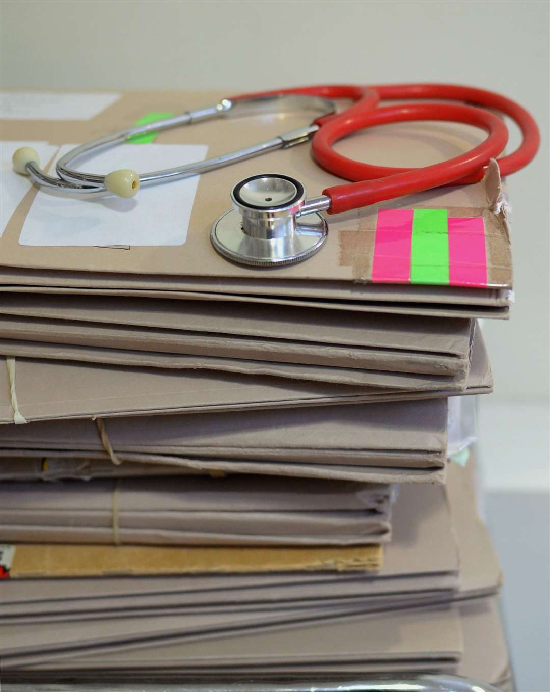 A stethoscope on top of patient’s files.