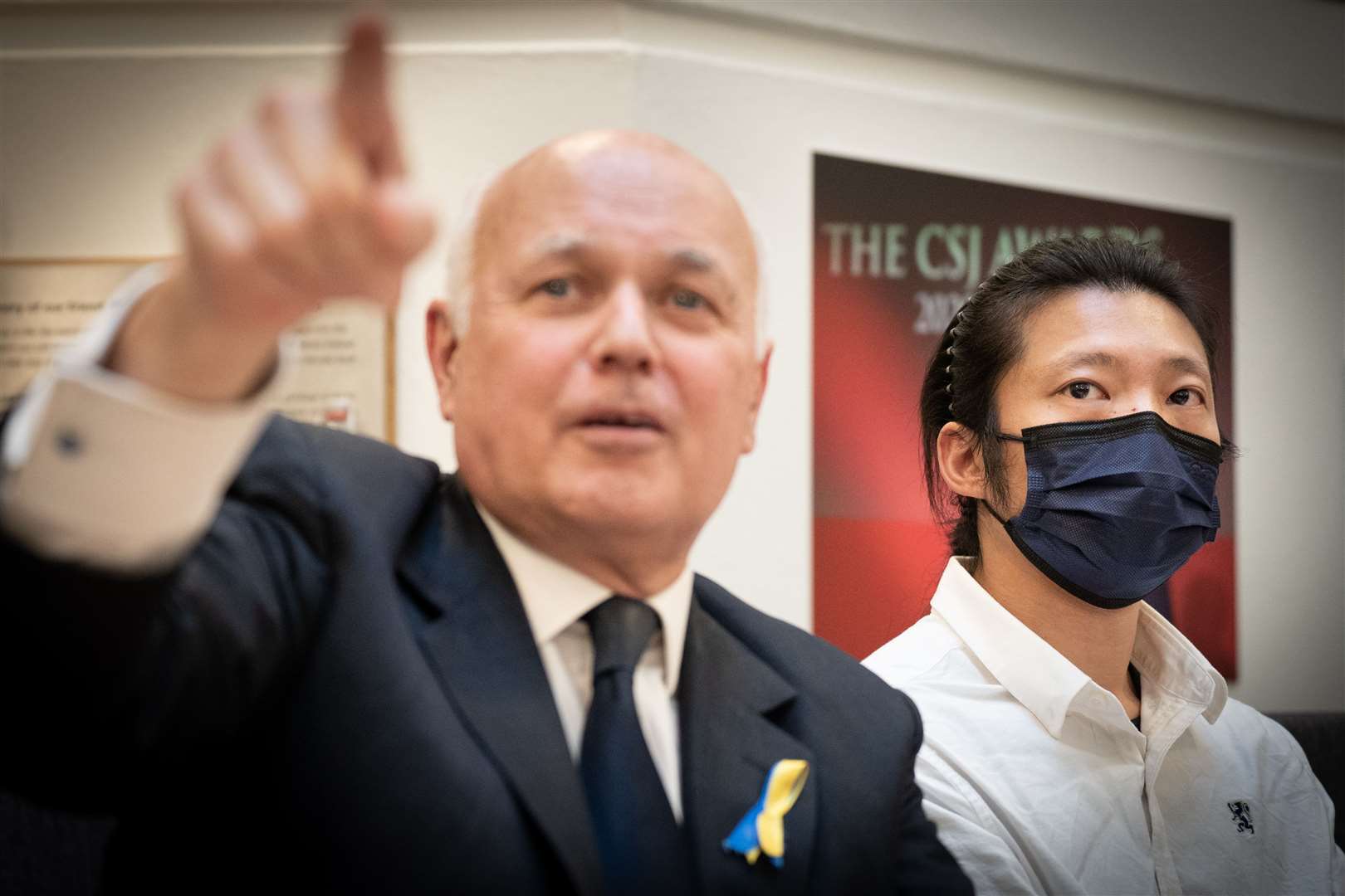Bob Chan (right), the Hong Kong protester allegedly assaulted at the Chinese consulate in Manchester, with Conservative MP Iain Duncan Smith at a press conference in central London (PA)