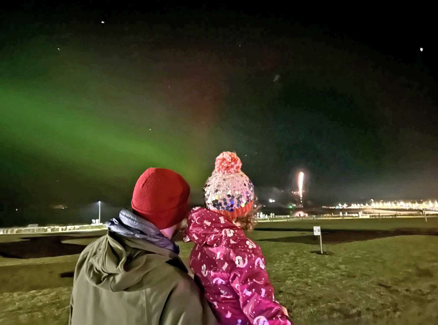 Magnus Davidson and two-year-old daughter Josie watching the Thurso fireworks display with the aurora above. Picture: Zoe Sutherland