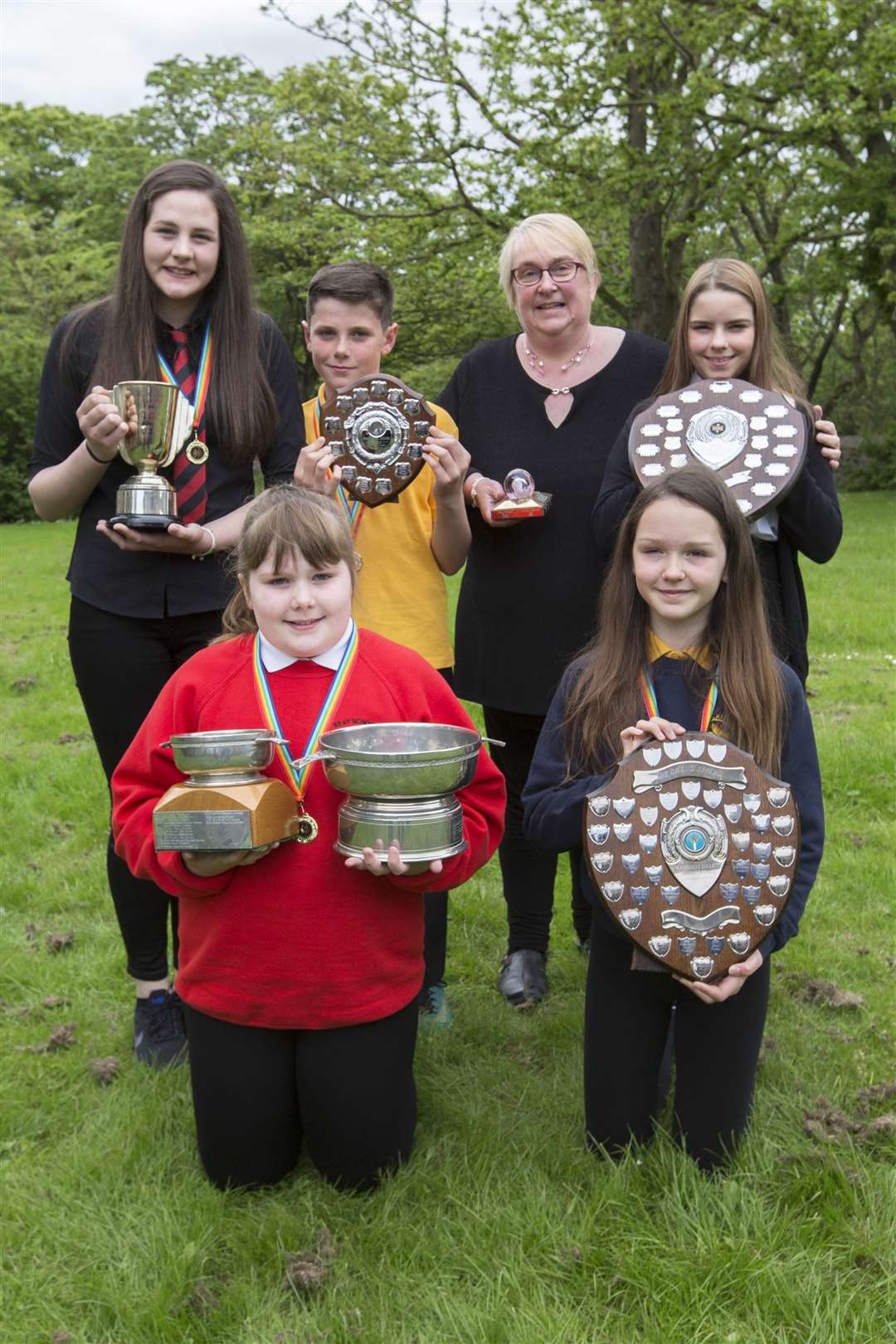 Alana Ross (front, left) won the Field of Noss Quaich, the overall Caithness dialect trophy and also the James M Gunn Dialect Quaich for P5 and under. Other trophy winners in the section were, from left, Morven Mackenzie, Halkirk, who won the Thurso Town Improvements Cup for S3-S6, her brother Liam who won the Henrietta Munro Shield for P6, Lesley Hendry, Wick, who received the Caithness Glass Paperweight Trophy for adults, Lily Byrne, Thurso High School, who received the John Munro Shield for S1-S2, and Shannon May (front, right), Halkirk, who won the Omand Shield for P7. Picture: Robert MacDonald / Northern Studios