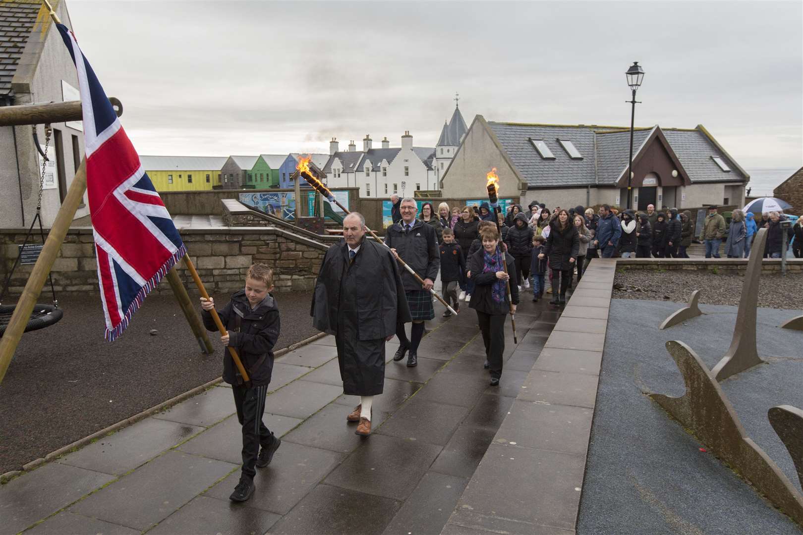 The procession makes its way towards the forge at John O'Groats, with 10-year-old Kyle Manson carrying the colours. Picture: Robert MacDonald / Northern Studios
