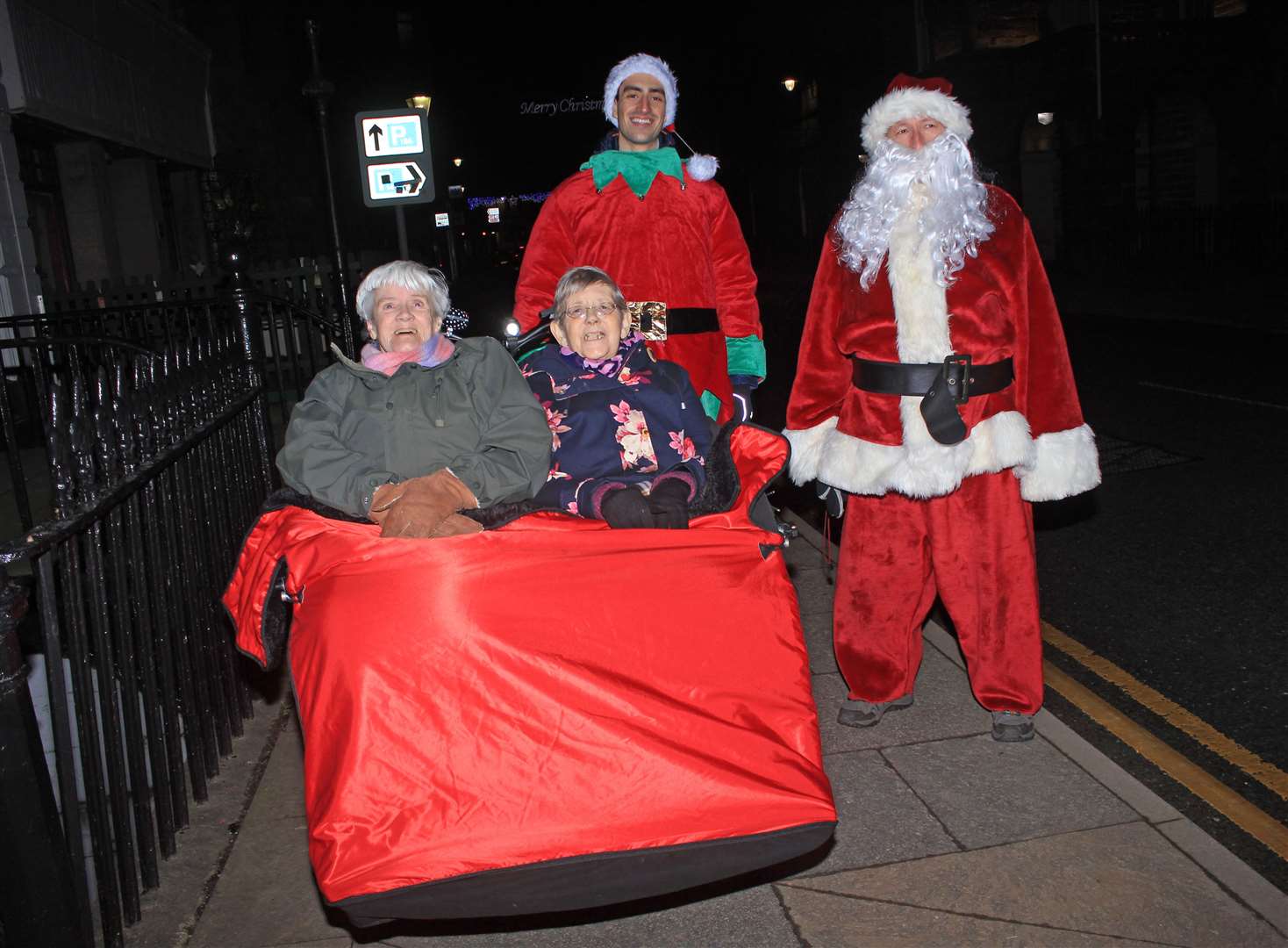 Care home residents Betty Ronaldson (left) and Jean Matthews are tucked up and ready to set off from Riverside House at the start of their trishaw tour on Monday night with George Ewing (right) and Yousuf El Shafei. Picture: Alan Hendry