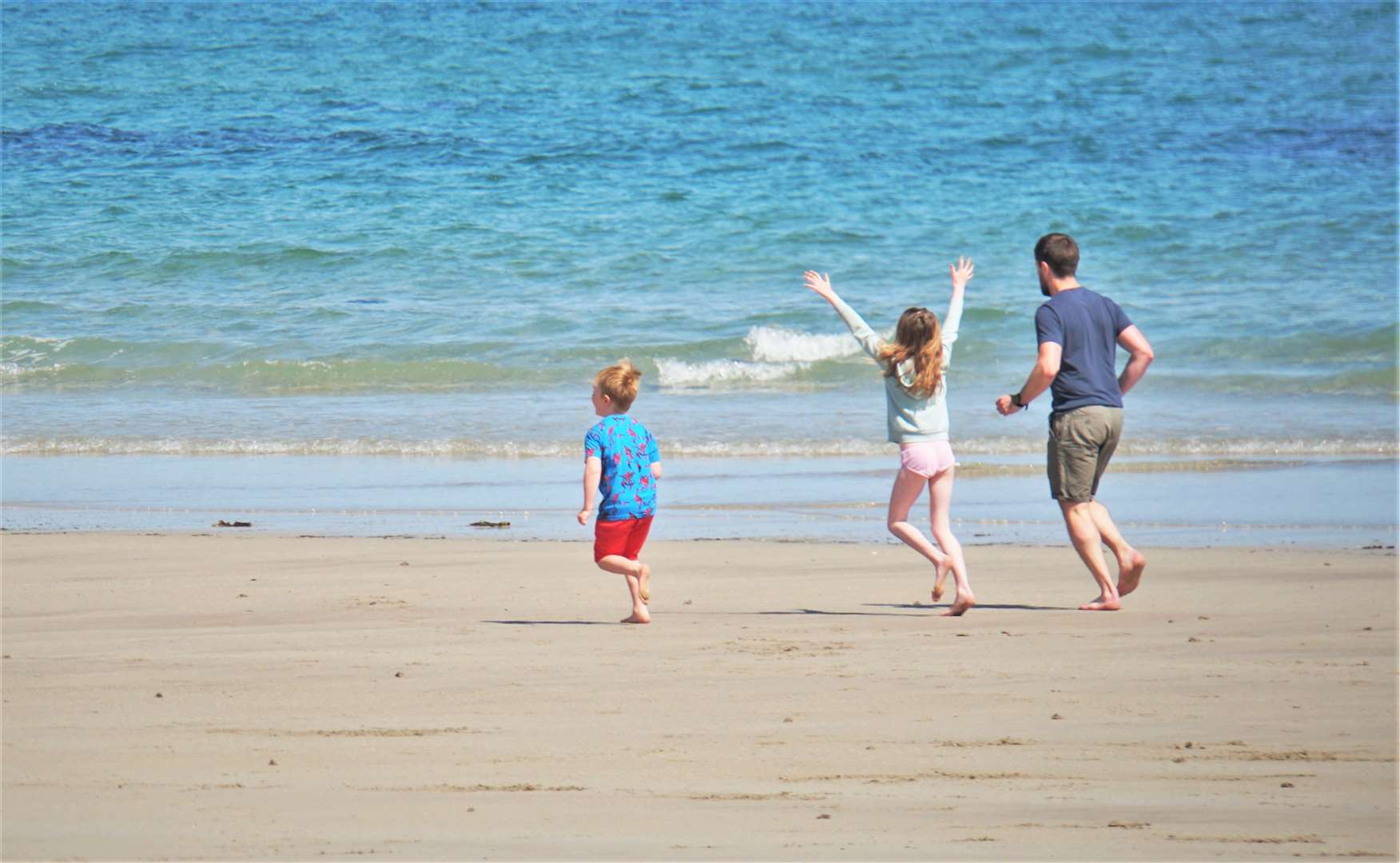 A family celebrates the beach being open. Pictures: DGS