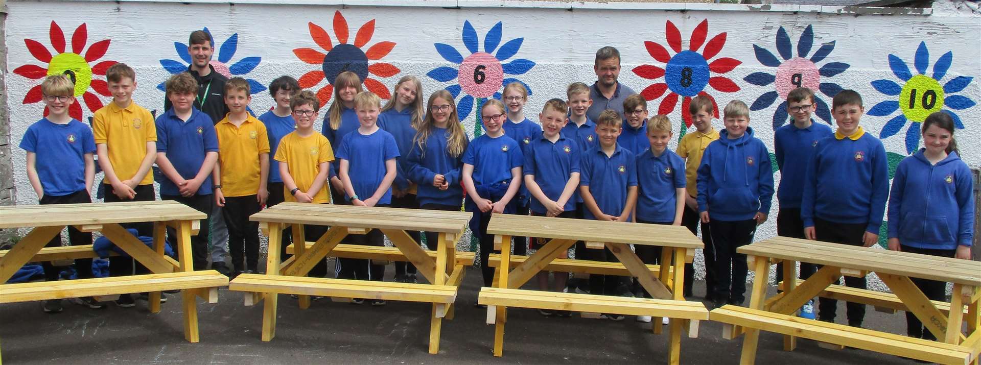 Primary five/six pupils with teacher David Hale (left) and parent volunteer and road crossing patroller, Ross Manson (right).