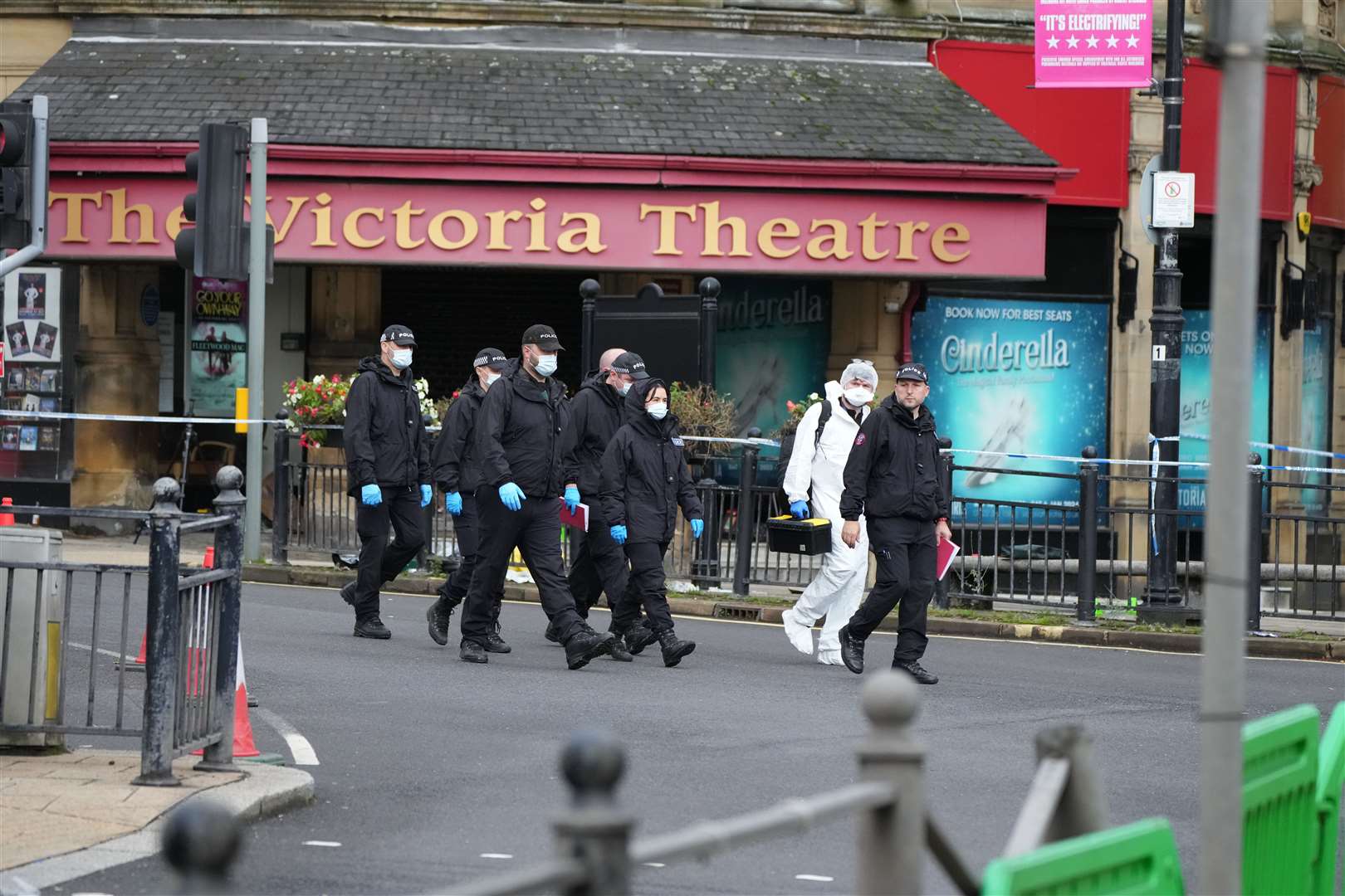 Police and forensic officers outside The Victoria Theatre near the scene of a triple stabbing in Commercial Street in Halifax (Danny Lawson/PA)
