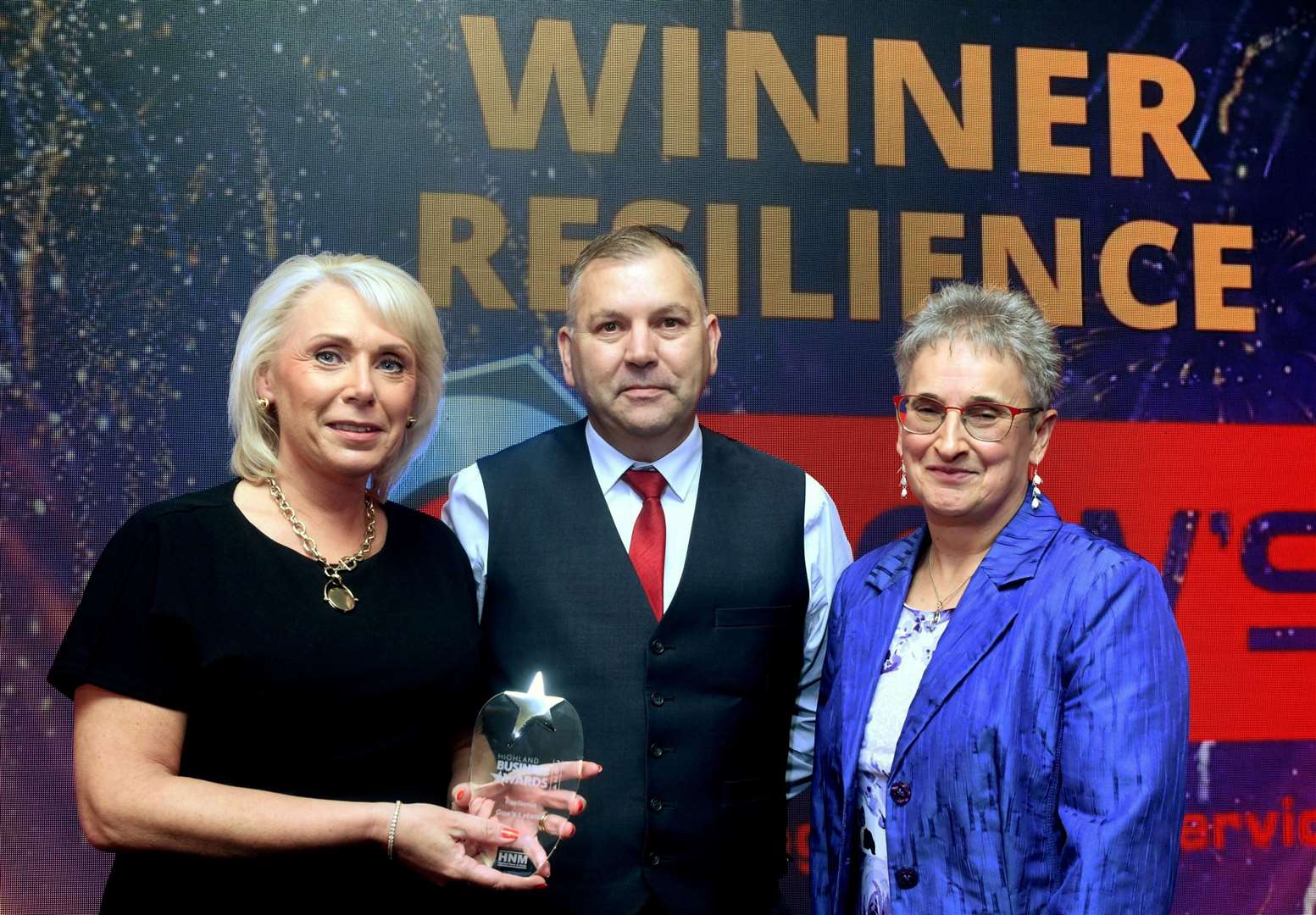 Sandra Gow and Wullie Robertson collect the Resilience award for Gow's Lybster from Trudy Morris, CEO of sponsor Caithness Chamber of Commerce. Picture: James Mackenzie