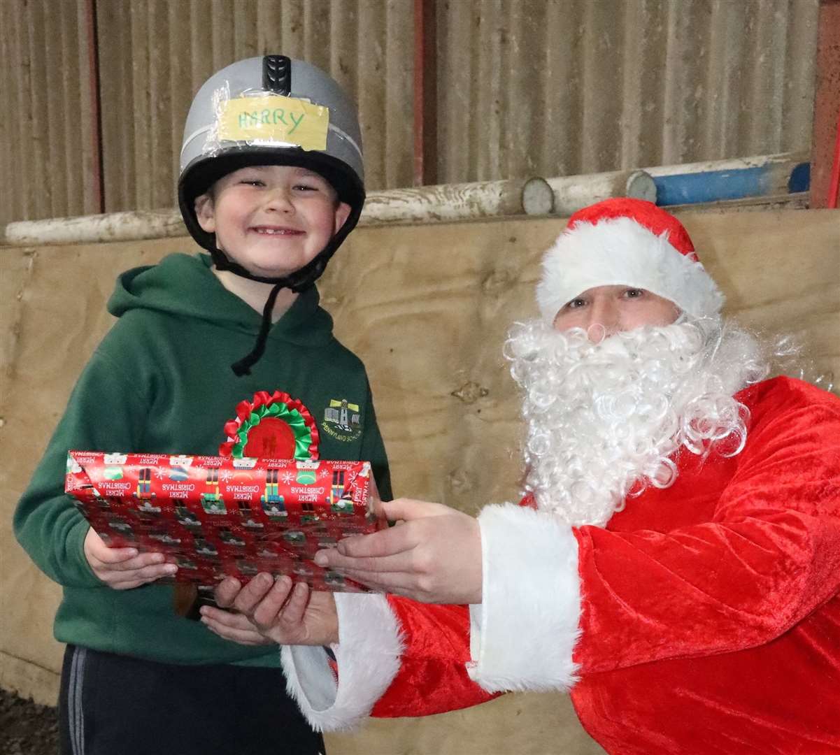 Santa pays a visit to RDA Christmas Show and young rider Harry Galloway is delighted to receive a gift. Picture: Neil Buchan