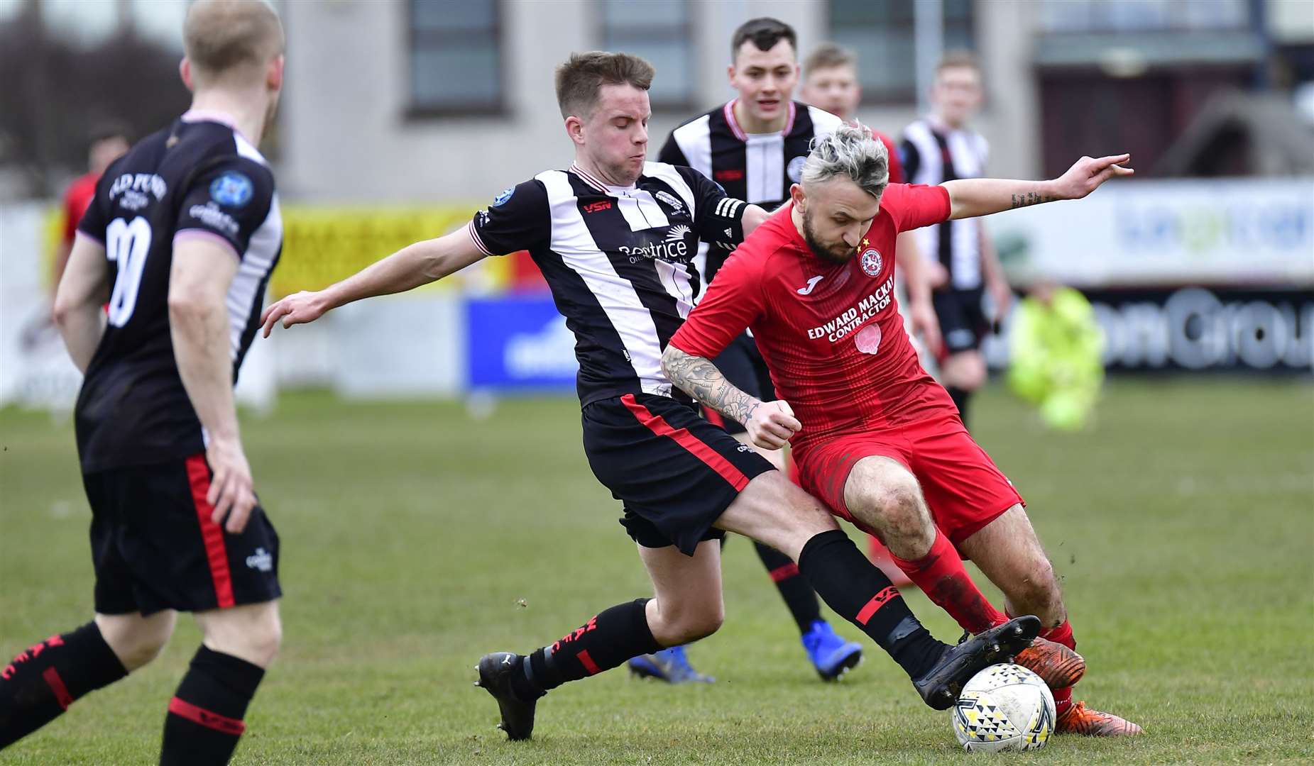 Wick Academy's Alan Farquhar tackles Paul Brindle of Brora during the north derby at Dudgeon Park on March 7 which turned out to be the last game of the season for both clubs. Picture: Mel Roger