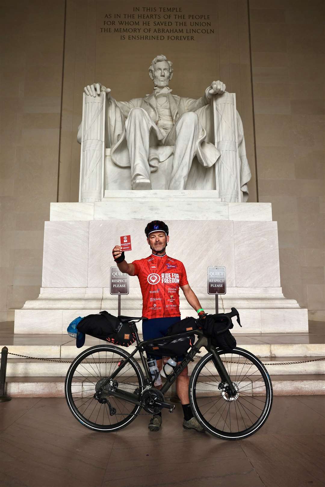 Gordon Miller at the Lincoln Memorial showing a red card to modern slavery and human trafficking in sport (James Aubry/Humble Hedgehog Productions/PA)
