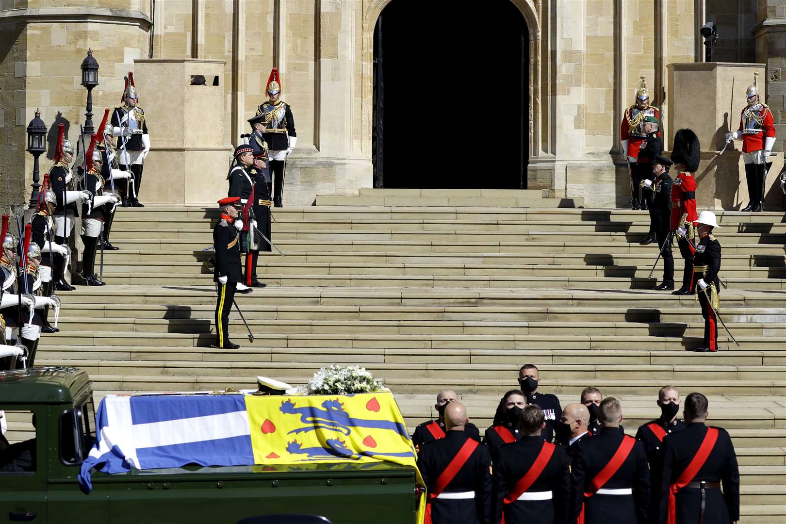 The Duke of Edinburgh’s coffin, covered with His Royal Highness’s Personal Standard, on the Land Rover Defender outside St George’s Chapel (Kirsty Wigglesworth/PA)