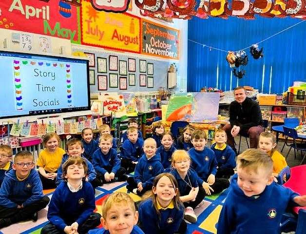 The children's faces are filled with glee at this book reading session.