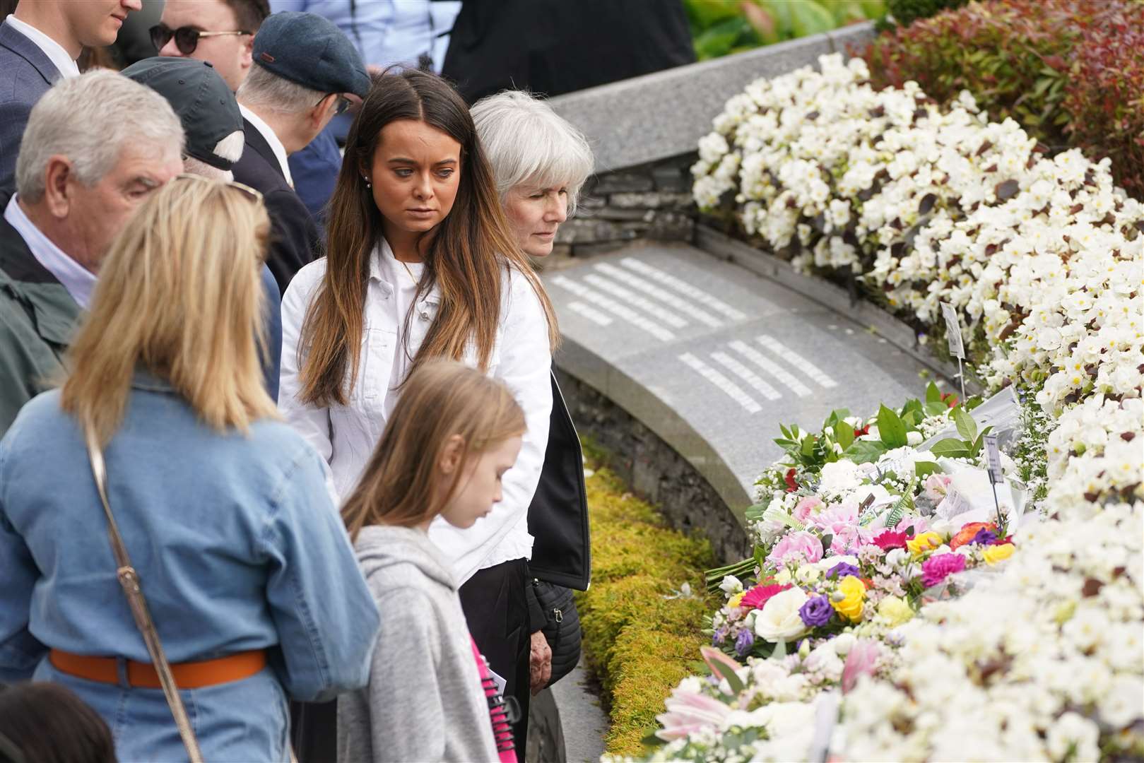 People gather on Sunday following a service to mark the 25th anniversary of the bombing that devastated Omagh in 1998, at the Memorial Gardens in Omagh, Co Tyrone (Brian Lawless/PA)