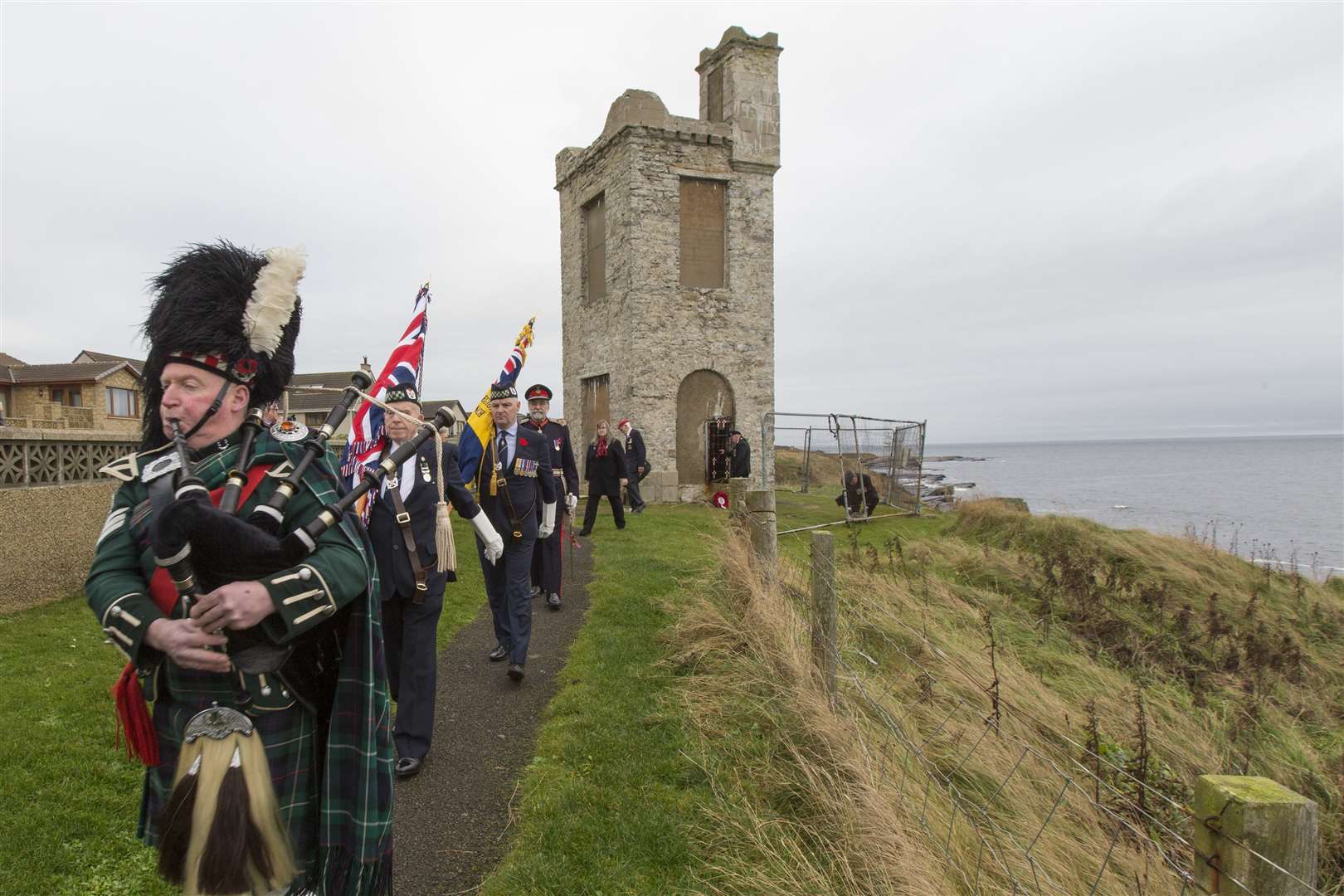Pipers lead the colours and the parade away from the Soldiers' Tower at Wick's North Head following a short service on Saturday morning. Picture: Robert MacDonald / Northern Studios