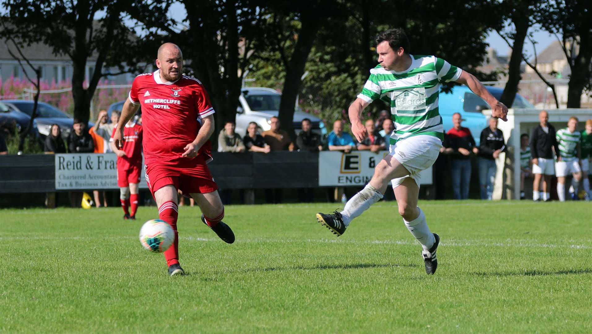 Michael Smith fires in Castletown's second goal past Groats defender Stewart Ross. Picture: James Gunn