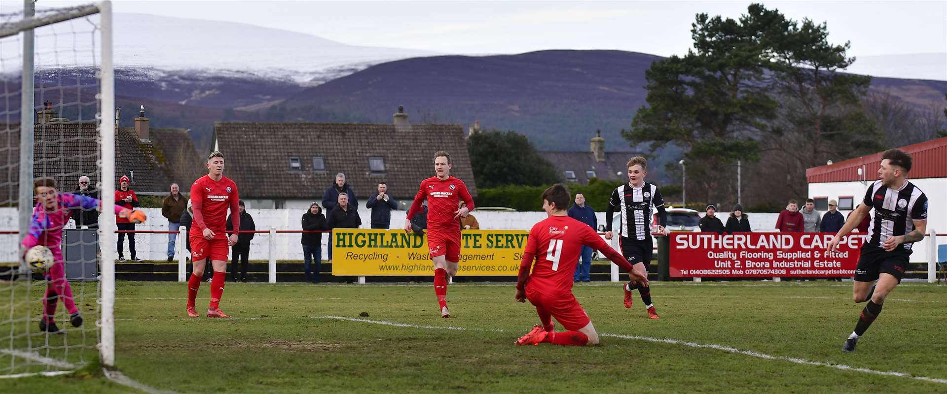 Jack Henry thumps the ball past substitute keeper Ruardhri Nicol to restore Wick Academy's lead in the far north derby at Brora. Picture: Mel Roger