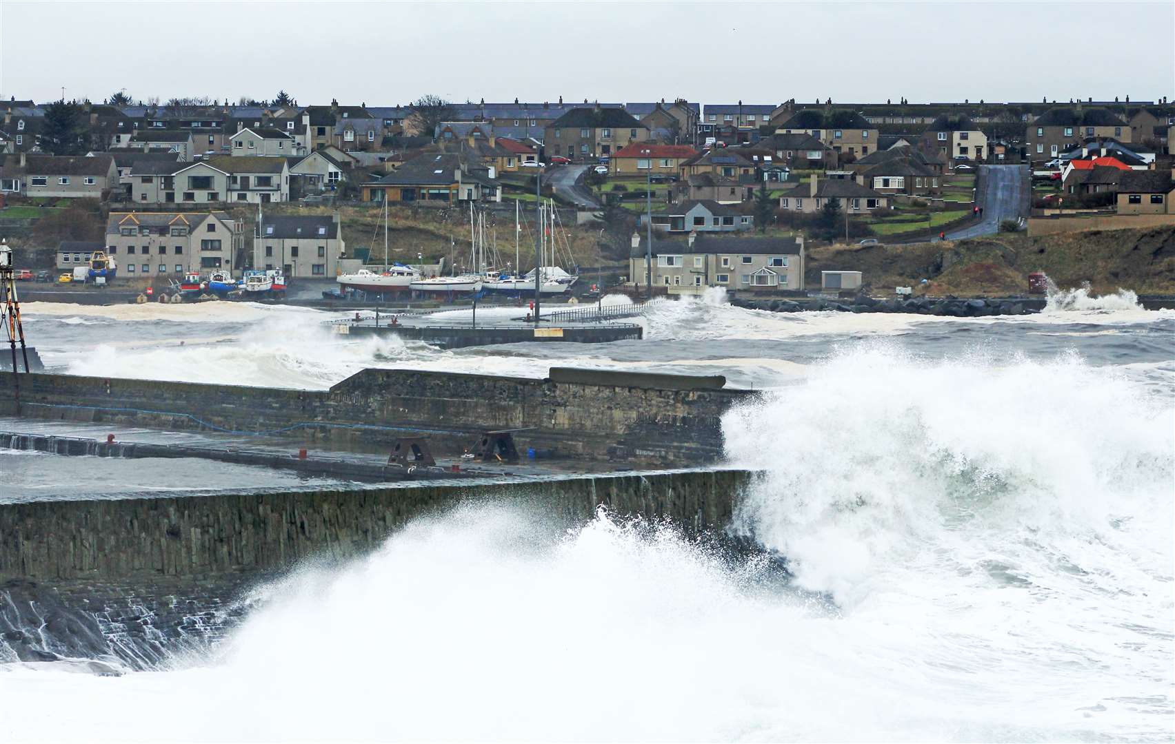 Waves surging towards the harbour entrance at Wick on Sunday afternoon. Picture: Alan Hendry