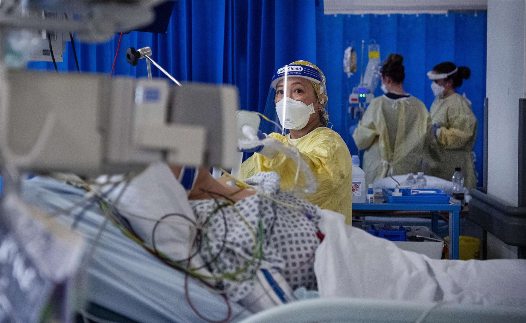 A nurse works on a patient in the Intensive Care Unit (Victoria Jones/PA)