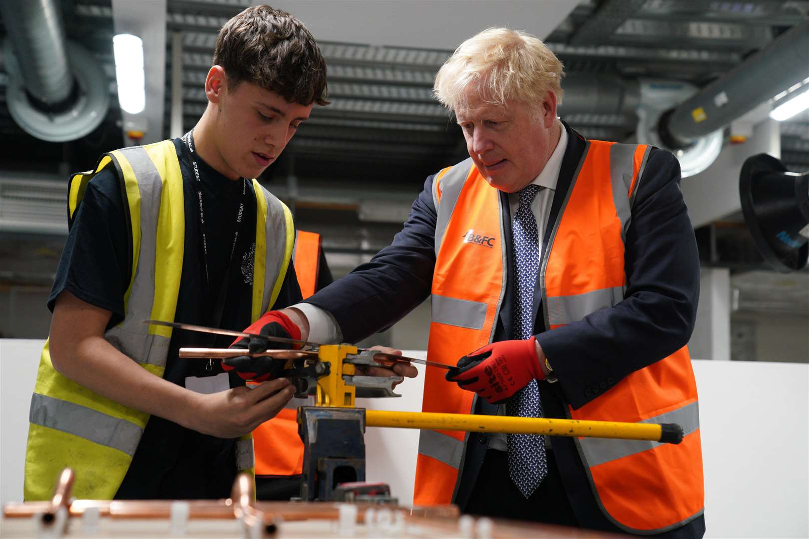 Mr Johnson was also shown how to bend copper piping (Pegter Byrne/PA)