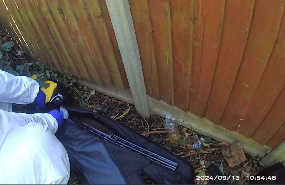 A forensics officer with the shotgun in a black holdall (Bedfordshire Police/PA)