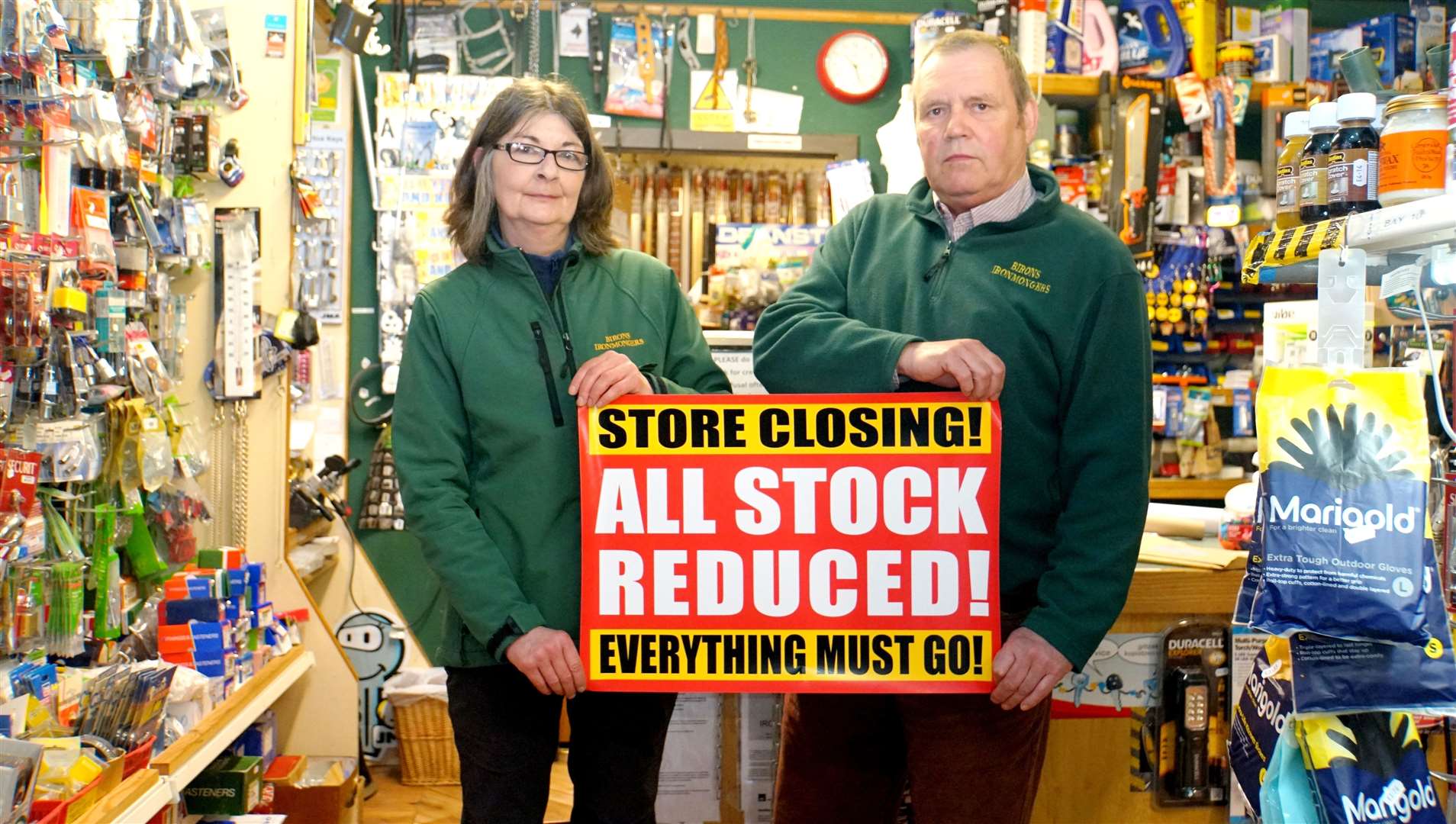 Kevin Milkins of Birons in Bridge Street holds the 'closing down' sign along with shop employee Karyn Fraser. Picture: DGS