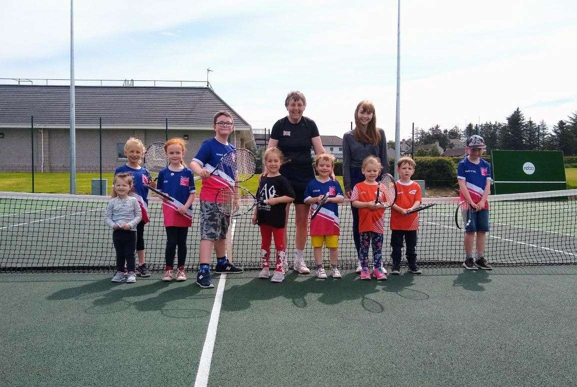Coach Carole Cameron and young leader Ellie Sutherland with some of the 4-7 age group taking part in LTA Tennis for Kids at Thurso’s Millbank courts this summer.