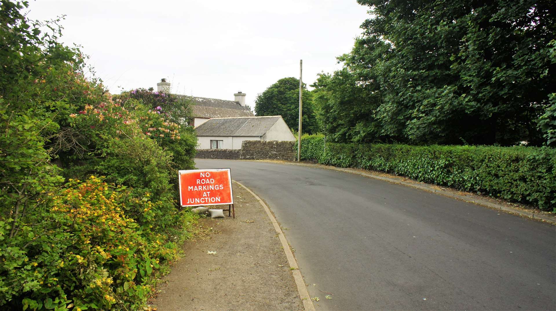 A notice warns that there are no road markings on the approach to the Watten crossroads. Picture: DGS