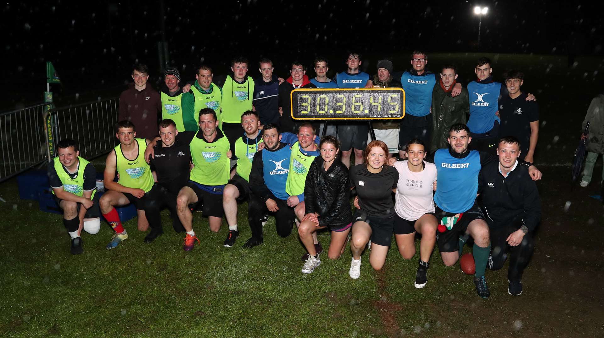 Caithness players celebrating their successful assault on the Guinness World Record for touch rugby, with the clock showing the new best time. Picture: James Gunn