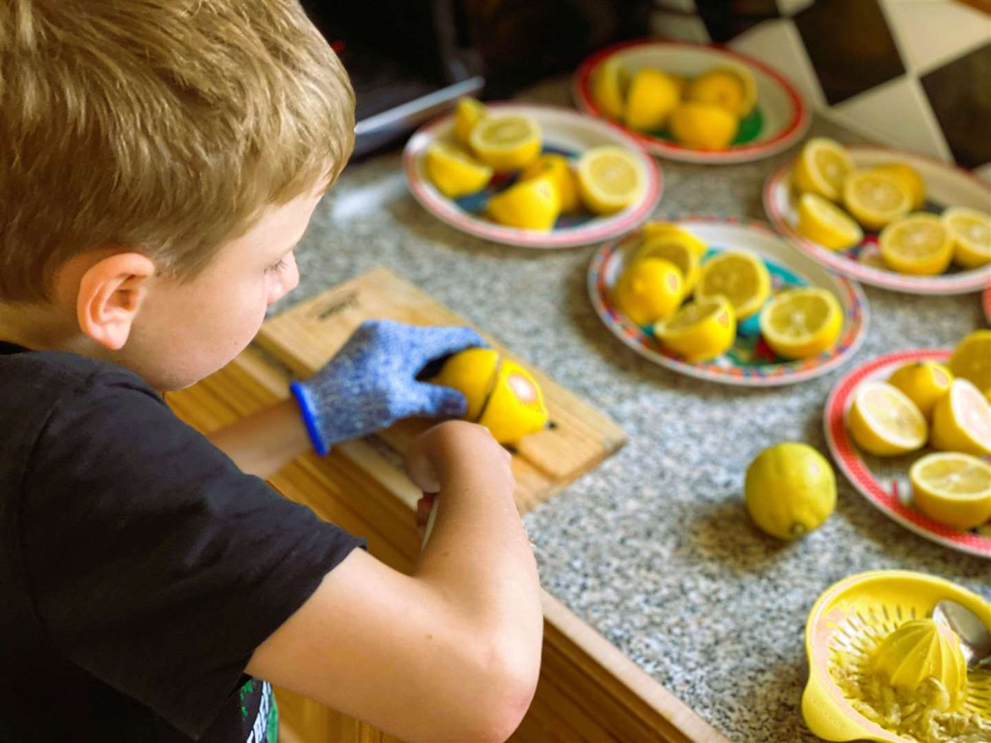 Sammie is supervised as he carefully cuts up lemons for the delicious lemonade recipe.