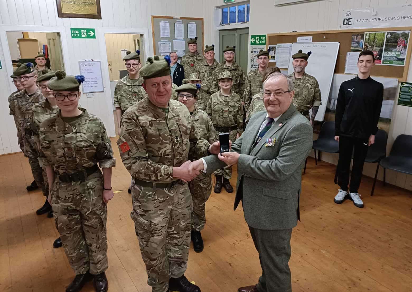 Major McLean (right) receiving the 2nd Clasp to the Cadet Force Medal by Major George MacDonald at Halkirk Detachment.
