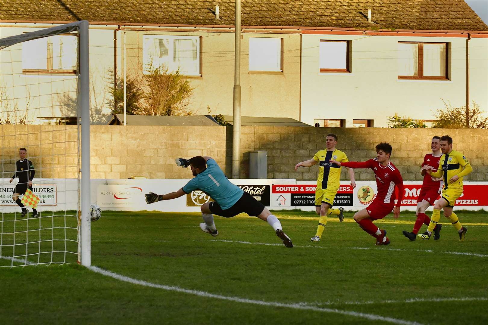 Craig Gunn fires the ball past Lossiemouth goalkeeper Stewart Black to open scoring for the Scorries. Picture: Mel Roger