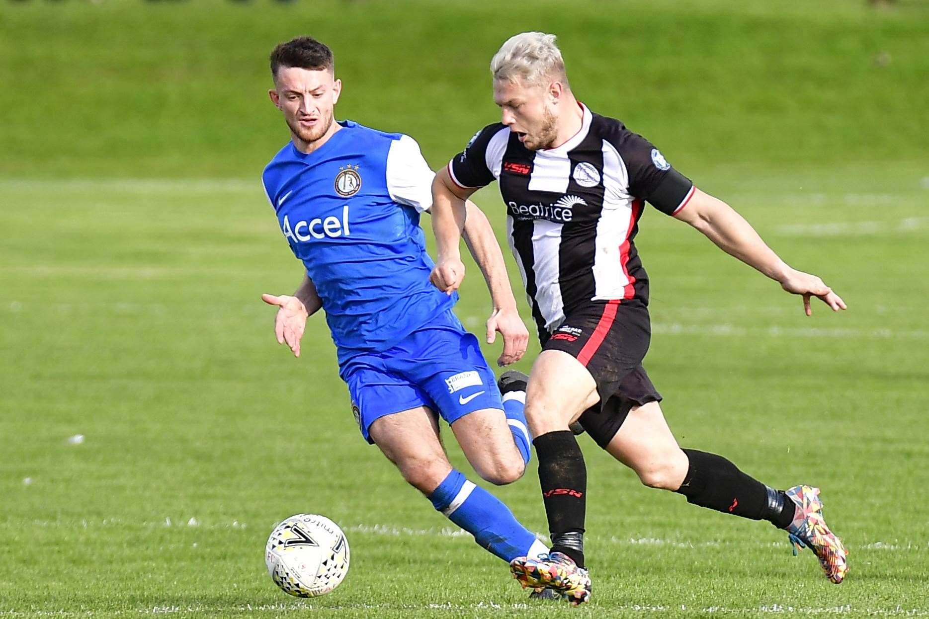 Wick Academy's Jack Halliday powers past Paul Scobie of Lochee United in the Scottish Cup last weekend. Picture: Mel Roger