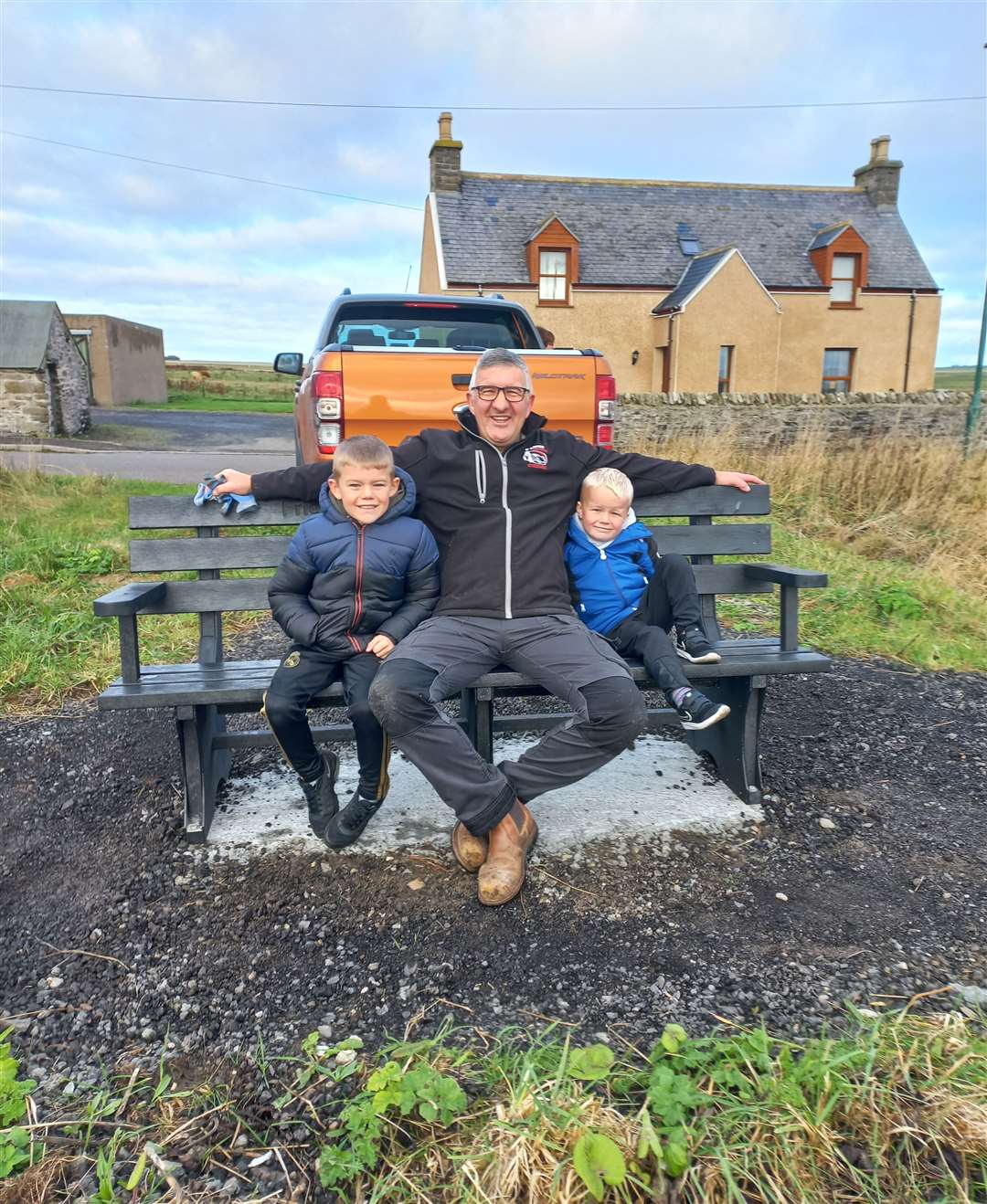 Willie Watt of Wick Paths Group and his two helpers – grandsons Ryan Little (7) and his brother Jack (4) – on the new Broadhaven bench.
