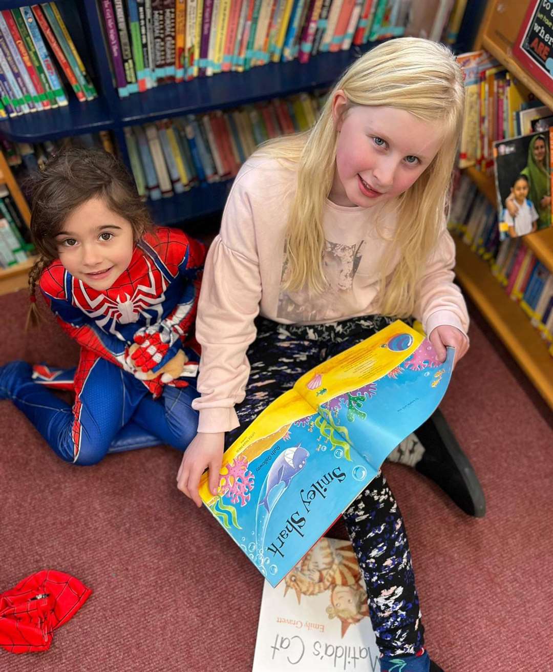 Spidergirl took part in paired reading activities with her reading buddy.