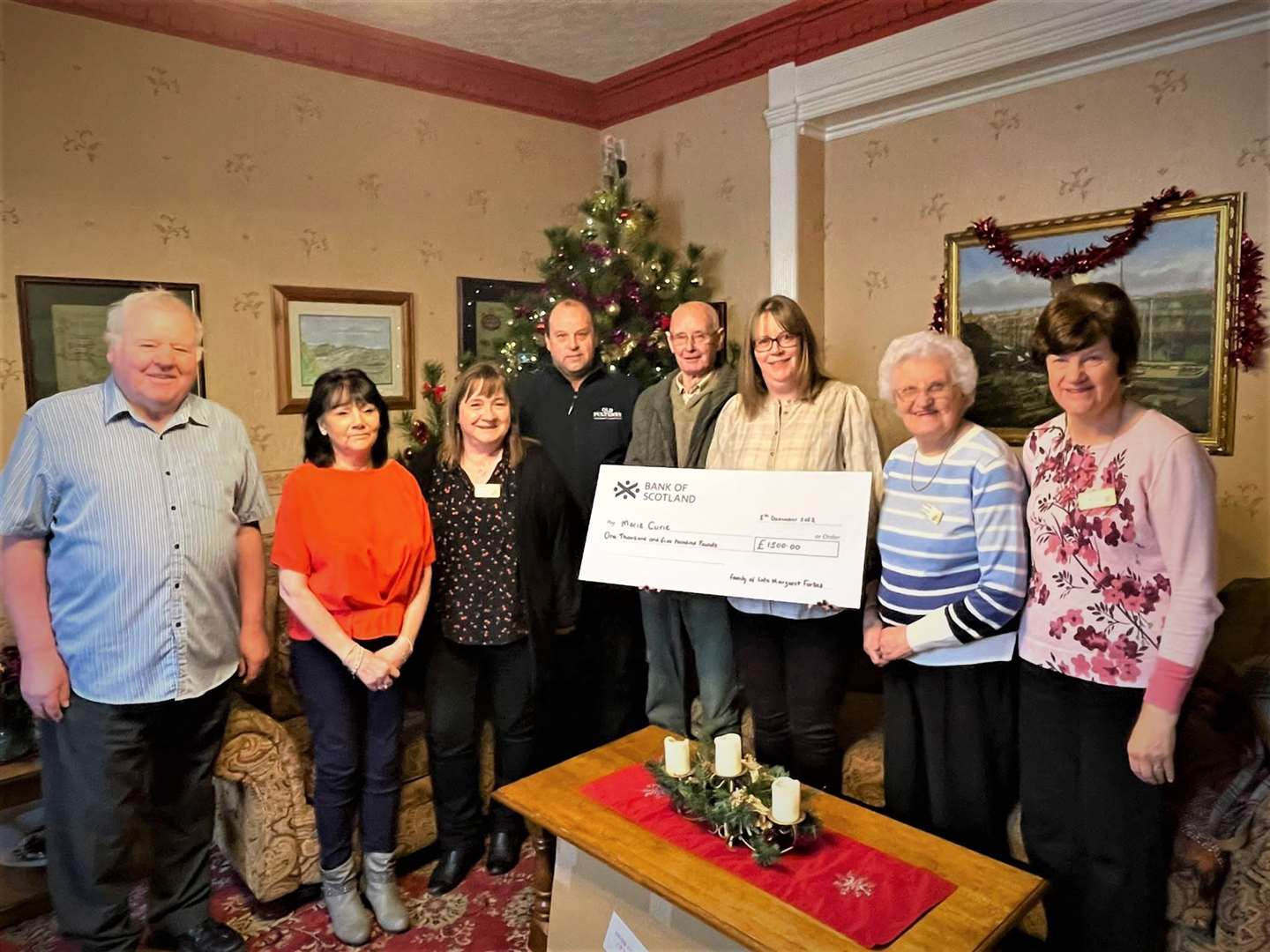 Handing over the cheque (from left to right) Bruce Simpson, Janette Mackenzie (treasurer, Marie Curie Wick Fundraising Group), Ann Sargent (chairperson), Kenneth Forbes, David Forbes, Alison Duncan, Lottie Shearer (committe member), Barbara Nicol (secretary).