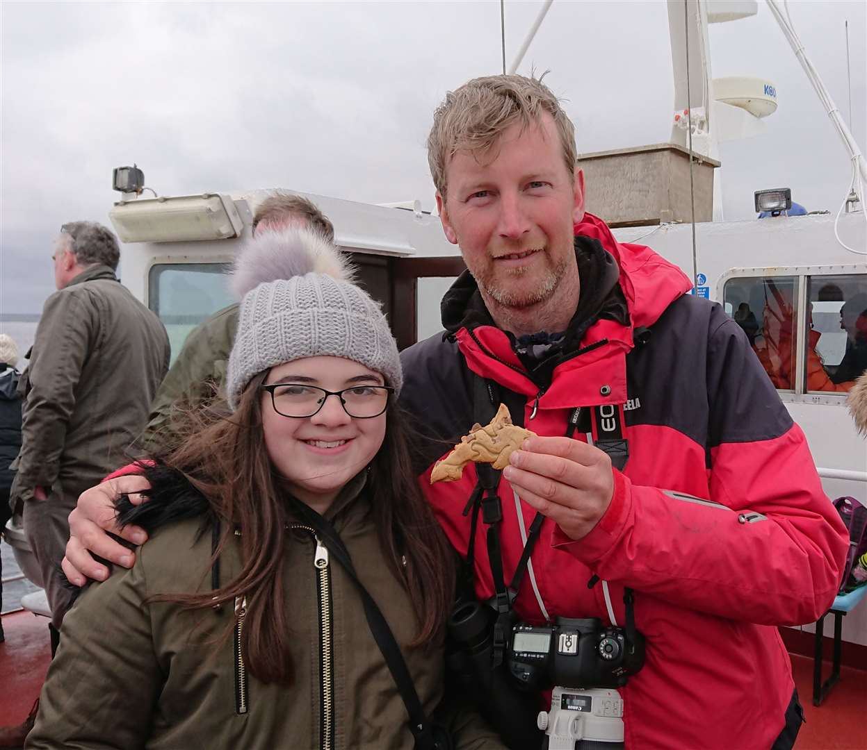 Steve Truluck with one of the young orca watchers, Freya Webb, on the Pentland Venture. Freya baked some orca-shaped cookies for other watchers.