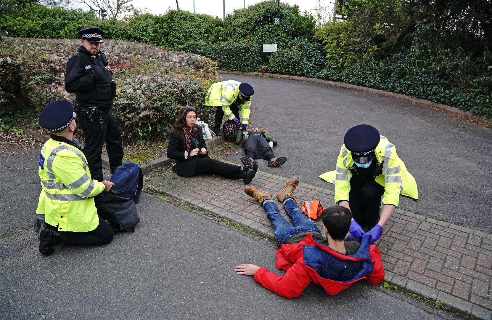 Protesters from Insulate Britain are arrested by police in the car park of the DoubleTree by Hilton at Dartford Crossing (Jonathan Brady/PA)