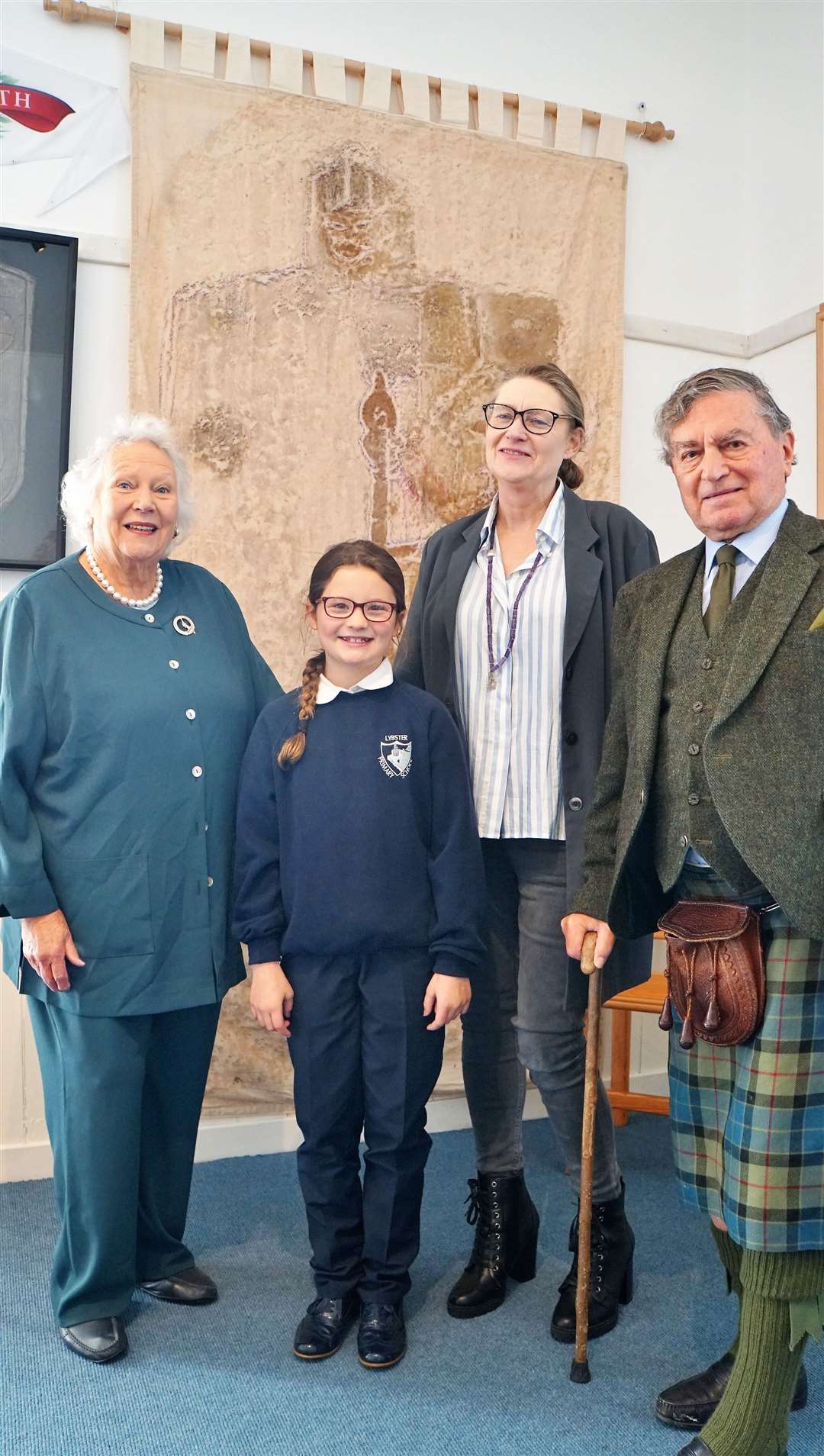 Bunty Gunn, a Lybster Primary pupil, Merran Gunn and clan chief Iain Gunn at the Clan Gunn Centre in Latheron in 2008. A rubbing taken of the Westford Knight carving is behind the group. Picture: DGS