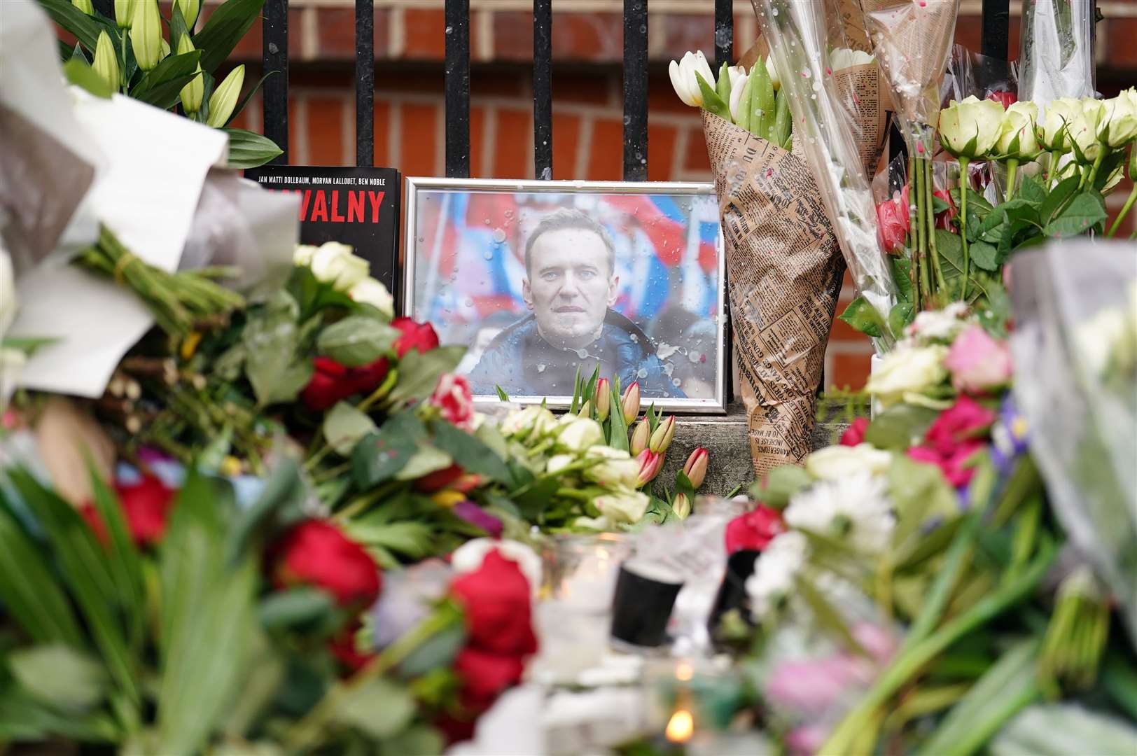 Floral tributes outside the Russian Embassy in London for Alexei Navalny (Jordan Pettitt/PA)