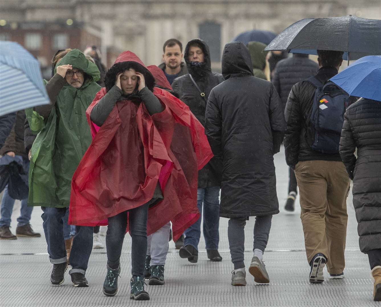 People braved the weather as they crossed the Millennium Bridge in London (Jeff Moore/PA)