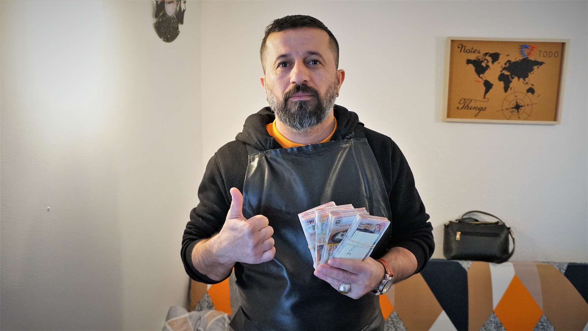 Ismail Dogrulmaz, who runs Derya's Turkish Barber shop in Thurso, with some of the money he raised for the earthquake victims. He will travel to Turkey with his wife and distribute the donated money, along with some of their own, to families affected by the disaster. Picture: DGS